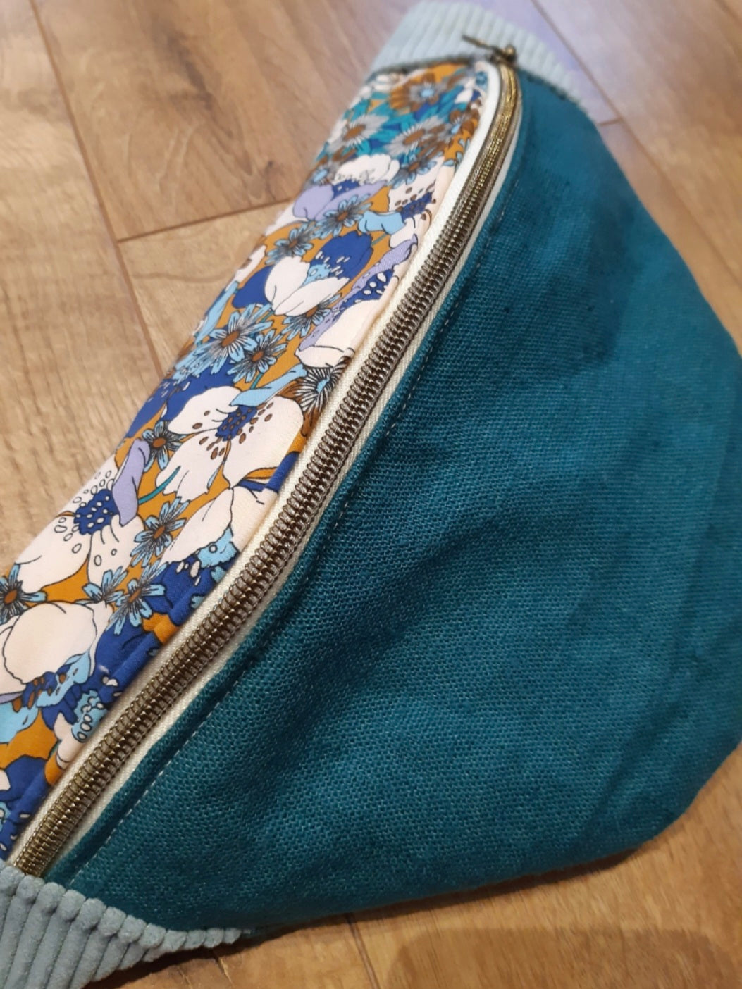 Sac banane en lin vert et rabat fleurs.
